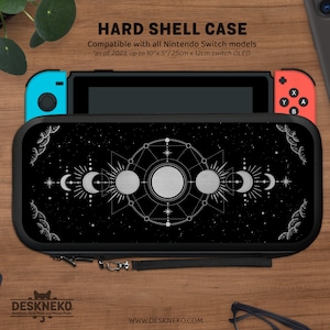 May include: Black hard shell case for Nintendo Switch models, featuring a celestial design with moons, stars, and suns. The case is compatible with models up to 10" x 5" and includes a wrist strap. The text "HARD SHELL CASE" is visible.
