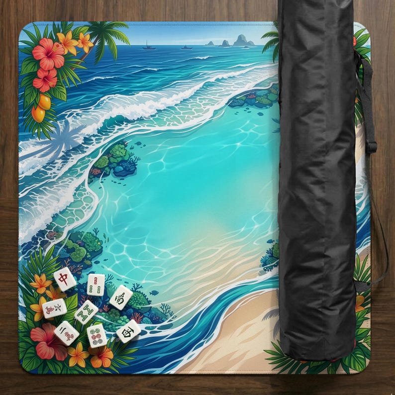 May include: A colorful Mahjong mat featuring a tropical beach scene with turquoise water, white waves, and a sandy shore. Palm trees, flowers, and Mahjong tiles are visible. A black carrying case is rolled up on the side.