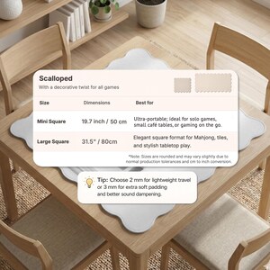 May include: A light gray, scalloped game mat on a wooden table. The text on the mat reads "Scalloped" and lists sizes: Mini Square at 19.7 inches and Large Square at 31.5 inches. The mat is designed for solo games and Mahjong.