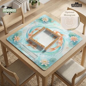 May include: A square desk mat featuring a light blue water background with two orange koi fish swimming in a circle, surrounded by pink lotus flowers and green lily pads. A wooden-textured square frame sits in the center of the mat.