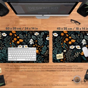 May include: Two black desk mats with floral patterns. One mat is 24 x 14 inches, the other is 18 x 14 inches. The mats feature a black background with white, orange, and teal floral designs. A keyboard and mouse are on the mats. The text "DeskNeko" and website address are visible.
