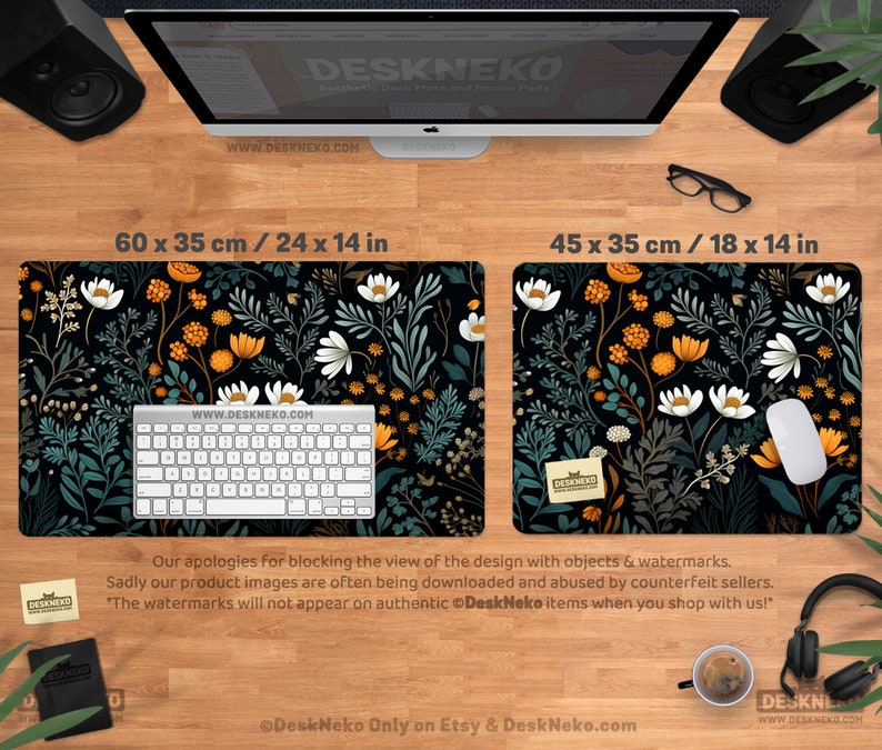 May include: Two black desk mats with floral patterns. One mat is 24 x 14 inches, the other is 18 x 14 inches. The mats feature a black background with white, orange, and teal floral designs. A keyboard and mouse are on the mats. The text "DeskNeko" and website address are visible.