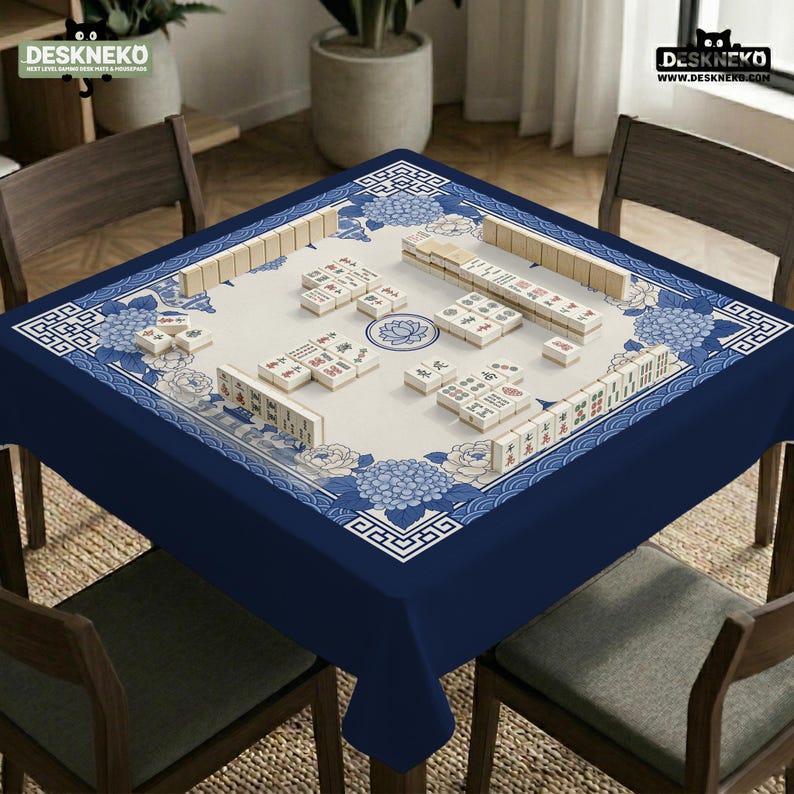May include: A blue and white Mahjong table set up for play. The table has a navy blue border and a cream-colored playing surface with floral and geometric patterns. The set includes tiles and is ready for a game.