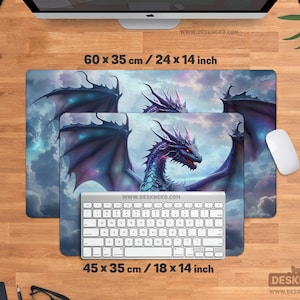 May include: Two rectangular mouse pads with a fantasy dragon design. The larger pad measures 24 x 14 inches, and the smaller one is 18 x 14 inches. The dragon is purple, blue, and red, with a cloudy sky background. A white keyboard and mouse are also present.