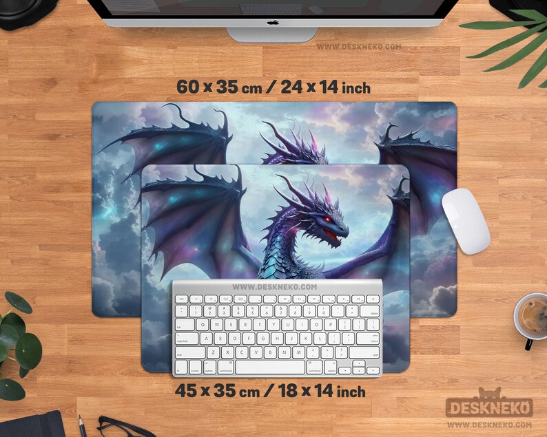 May include: Two rectangular mouse pads with a fantasy dragon design. The larger pad measures 24 x 14 inches, and the smaller one is 18 x 14 inches. The dragon is purple, blue, and red, with a cloudy sky background. A white keyboard and mouse are also present.
