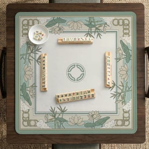 May include: A square Mahjong game table with a light green and white floral design. The table has a wooden frame and a playing surface with tiles and dice. The game is set up and ready to play.