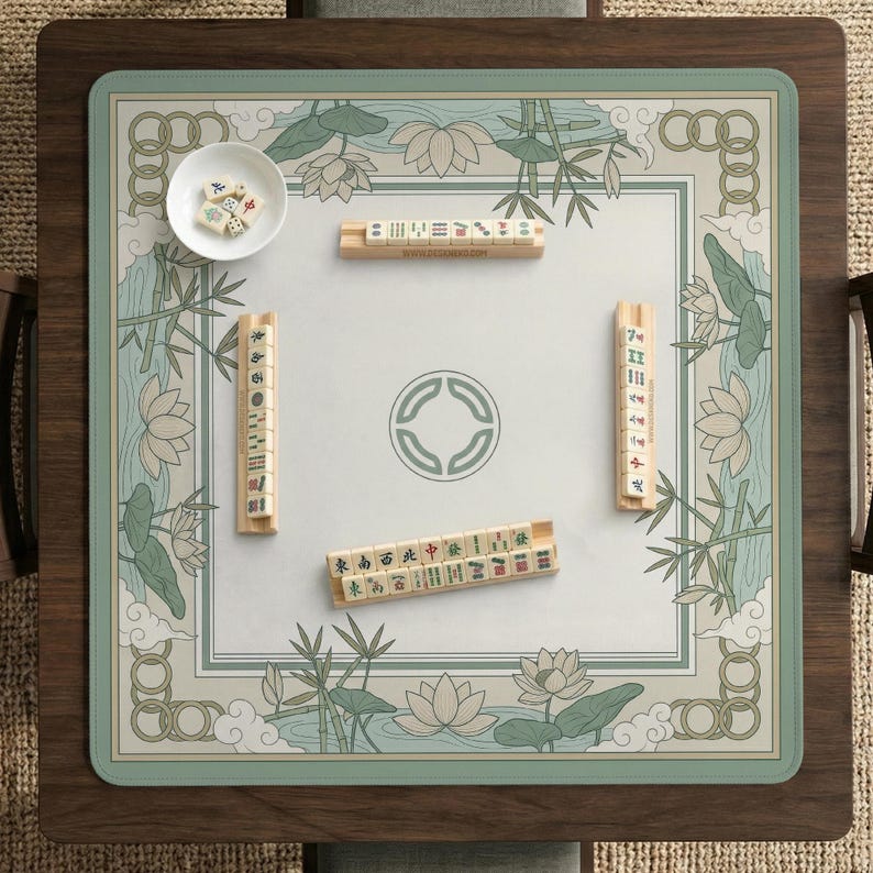 May include: A square Mahjong game table with a light green and white floral design. The table has a wooden frame and a playing surface with tiles and dice. The game is set up and ready to play.
