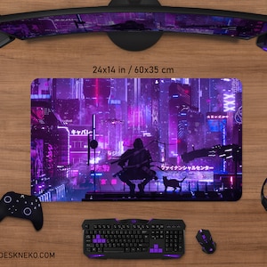 May include: A gaming mouse pad with a futuristic cityscape design in purple and black. The mouse pad measures 24 x 14 inches. A black keyboard, mouse, controller, and headset are also visible.