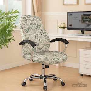 May include: An office chair with a botanical print of green leaves and stems on a cream background. The chair has black armrests, a chrome base, and rolling wheels. The chair is in a home office setting.