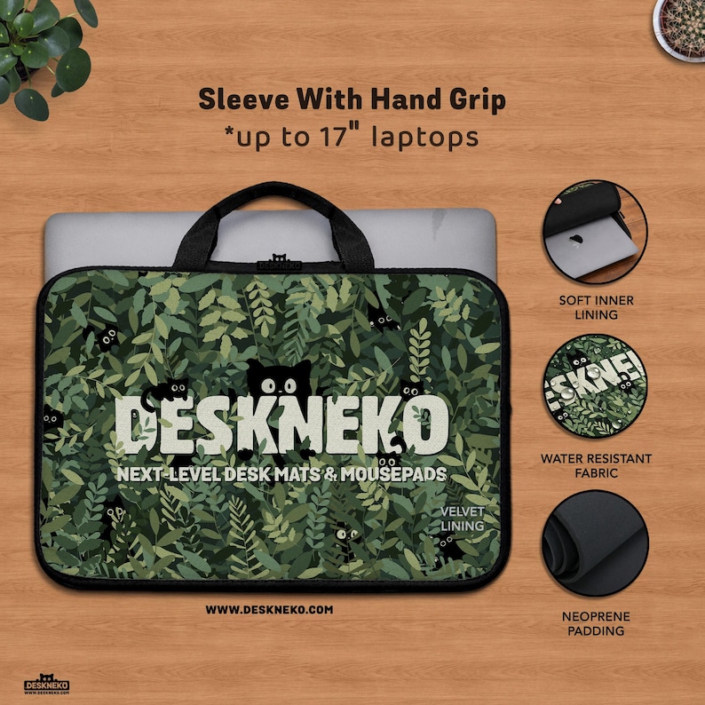 Product photo of a DeskNeko laptop sleeve with integrated hand grip. The sleeve features a high resolution photo print. A padded black fabric handle is attached at the top for easy carrying, with a Macbook Pro laptop partially inserted in the sleeve, showing compatibility up to 17-inch laptops. Black piping and a zipper closure frame the sleeve. Icons highlight the soft inner lining, water-resistant fabric, and thick neoprene padding for impact protection.