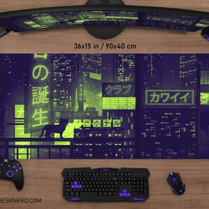 May include: A purple and green desk mat with a cityscape design, featuring Japanese text and a black cat silhouette. The mat measures 36x15 inches. A keyboard, mouse, and controller are visible.