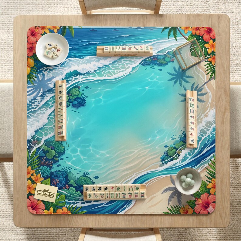 May include: A square mahjong mat featuring a tropical beach scene with turquoise water, white waves, and coral reefs. The border is decorated with vibrant red and orange hibiscus flowers and green palm leaves. Four wooden tile racks hold mahjong tiles.