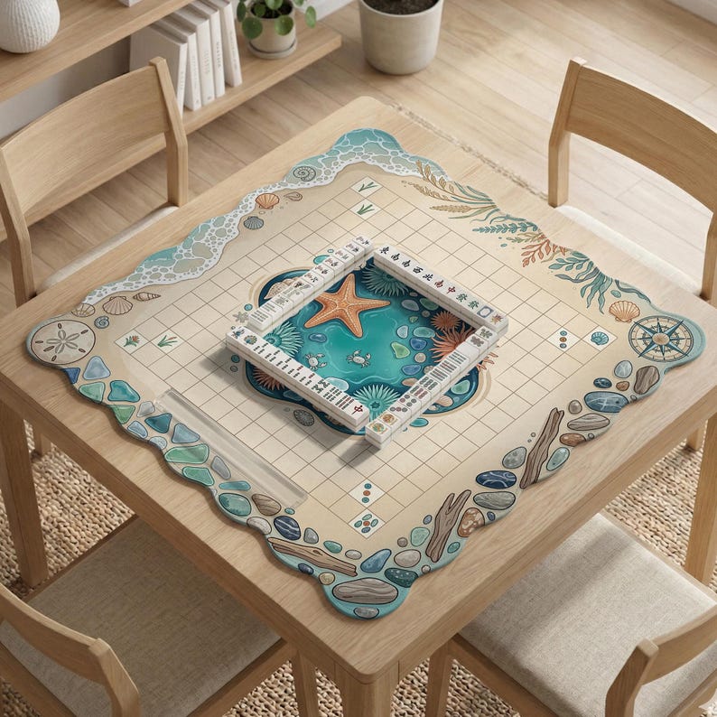 May include: A square wooden table with a beach-themed game board. The board features a central ocean scene with a starfish and a game piece. The border has a wave design, seashells, and pebbles. A game piece is placed on the board.