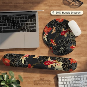 May include: A black and gold koi fish design mousepad and wrist rest set. The set features red flowers and koi fish on a black background. A laptop, mouse, and keyboard are also visible.