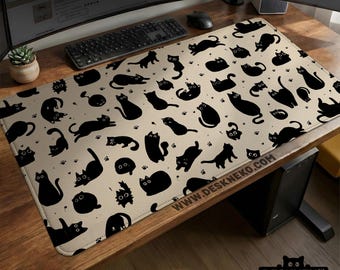 May include: A beige rectangular desk mat with a repeating pattern of black cat silhouettes in different poses. The mat includes paw prints and the text "WWW.DESKNEKO.COM". The desk mat is designed for use with a computer.