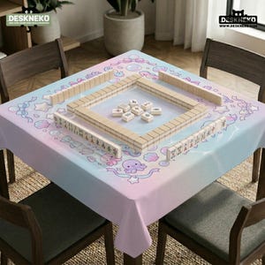 May include: A pastel-colored tablecloth with a whimsical design featuring sea creatures and bows. Wooden Mahjong tiles are arranged on the table. The text "DESKNEKO" is visible in the top left and right corners.