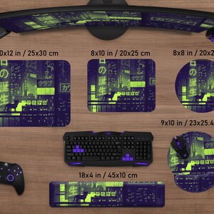 May include: A collection of gaming accessories featuring a neon cityscape design. Includes a mousepad (9x10 in), a keyboard wrist rest (18x4 in), and a rectangular mousepad (10x12 in). The design incorporates Japanese text and a silhouette of a dog.