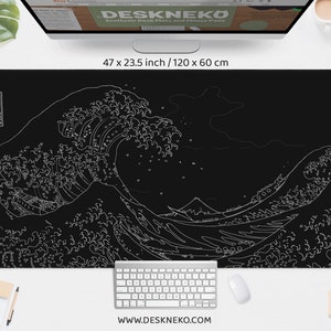 May include: Black desk mat featuring a white outline of Hokusai's "The Great Wave off Kanagawa" artwork. The mat measures 47 x 23.5 inches. A keyboard and mouse are visible on the mat. The website address www.DESKNEKO.com is printed at the bottom.