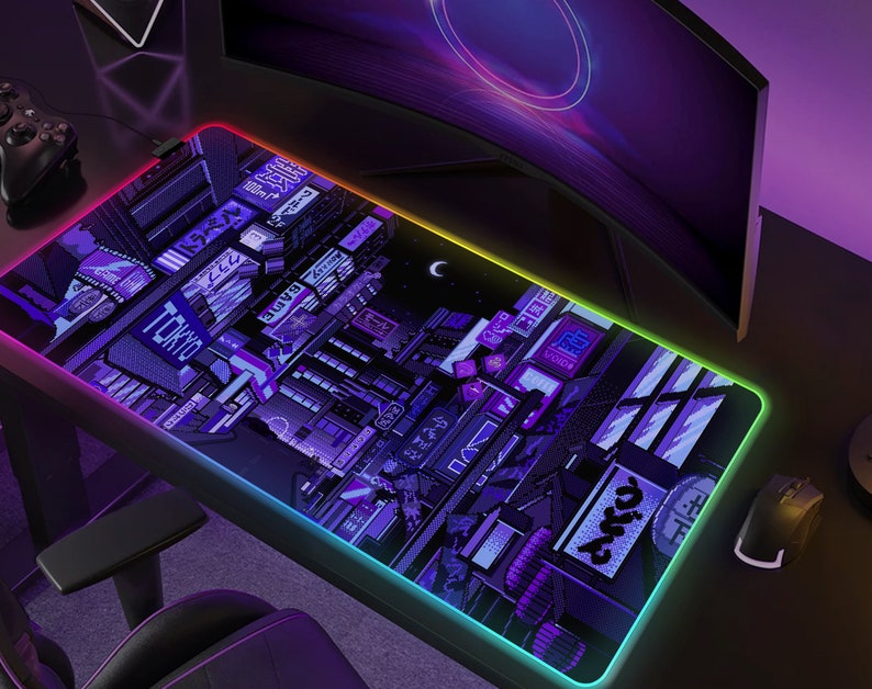 May include: A rectangular gaming mouse pad with a pixelated Tokyo cityscape design in shades of purple and blue. The pad has a glowing, multi-colored LED edge. The word "TOKYO" is visible on the pad.