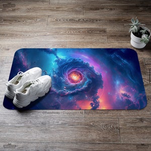 May include: A rectangular floor mat featuring a vibrant galaxy design with swirling blues, purples, and oranges. White sneakers are placed on the mat. A small potted succulent is in the background. The mat has the text "DeskNeko | Copyright | All Rights Reserved".