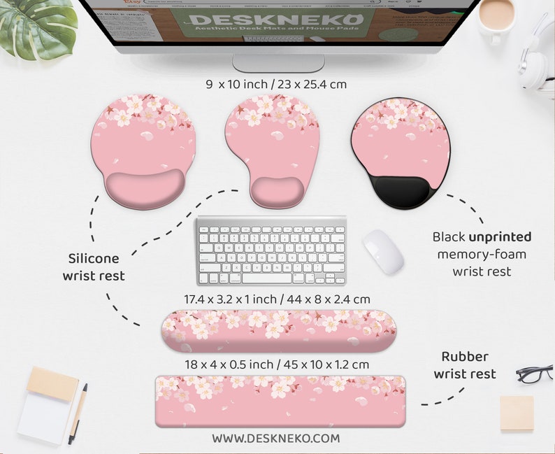 May include: A collection of desk accessories, including a silicone wrist rest, a black memory-foam wrist rest, and a rubber wrist rest. The items are pink with a white floral pattern. The dimensions are provided in inches and centimeters.