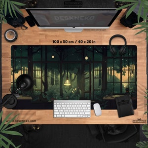 May include: A rectangular desk mat with a forest scene design, measuring 40 x 20 inches. The artwork depicts a lush, green forest viewed through large windows. A keyboard, mouse, and notebook are on the desk. The brand name "DESKNEKO" is visible.