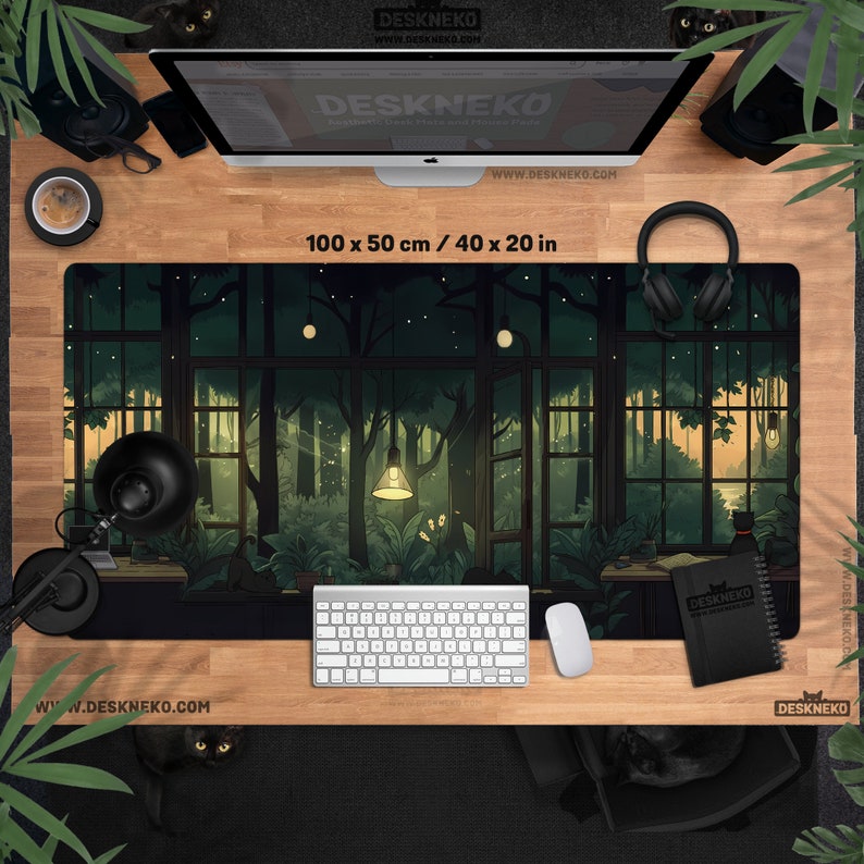 May include: A rectangular desk mat with a forest scene design, measuring 40 x 20 inches. The artwork depicts a lush, green forest viewed through large windows. A keyboard, mouse, and notebook are on the desk. The brand name "DESKNEKO" is visible.