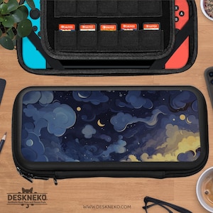May include: Black zippered case with a night sky design, featuring dark blue clouds, a crescent moon, and yellow accents. The case is open, revealing a black interior with game cartridge slots. The brand name "DESKNEKO" is visible.