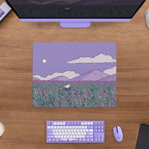 May include: A rectangular mousepad featuring a whimsical illustration of a character in a field of lavender flowers under a night sky with a full moon. The mousepad is surrounded by a computer monitor, keyboard, mouse, and headphones.