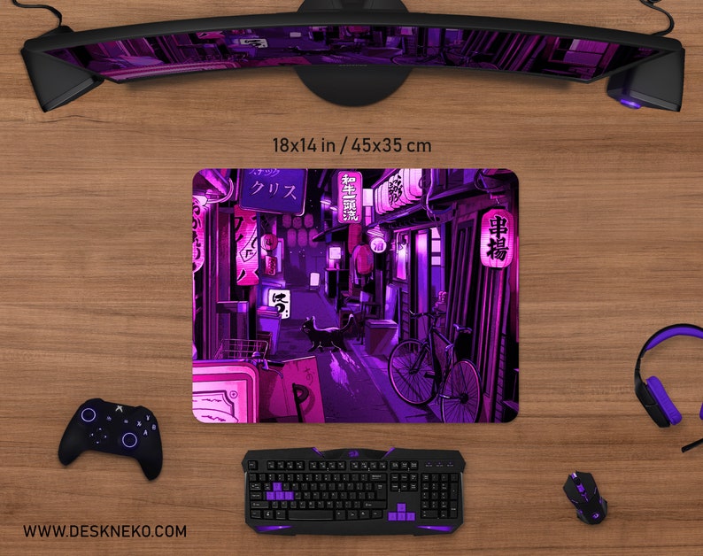 May include: A rectangular mouse pad, 18 x 14 inches, featuring a vibrant illustration of a Japanese street scene in shades of purple and pink. The design includes lanterns, a bicycle, and Japanese text. A black keyboard, mouse, and controller are visible.