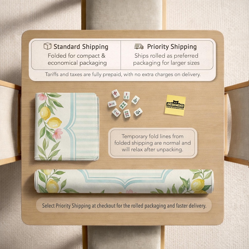 May include: A rolled and folded desk mat with a lemon and floral design. The mat is white with a light blue border and features lemons, pink flowers, and green leaves. The image also shows mahjong tiles and text about shipping options.