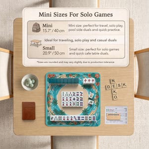 May include: A mini Mahjong set with a teal playing surface featuring a tropical design. The set includes tiles, dice, and a small brown booklet. The text on the sign reads "Mini Sizes For Solo Games". The mini size is 40 cm.