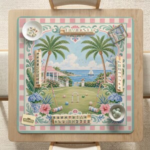 May include: A decorative game board featuring a tropical landscape with palm trees, a sailboat, and a croquet set. The board has a pink and white checkered border and includes game pieces and small bowls. The brand name "DESKNEKO" is visible.