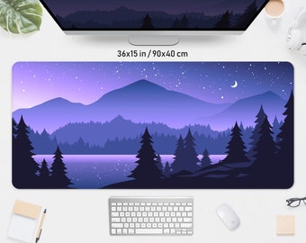 May include: A rectangular desk mat with a landscape design. The image shows a mountain range, a lake, and evergreen trees under a starry night sky with a crescent moon. The mat measures 90x40 cm.