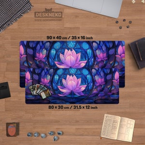 May include: Two rectangular desk mats with a stained-glass lotus flower design. The mats are 35 x 16 inches and 31.5 x 12 inches. The design features a purple lotus flower with blue and purple accents. The mats have the text "DESKNEKO" and "WWW.DESKNEKO.COM".