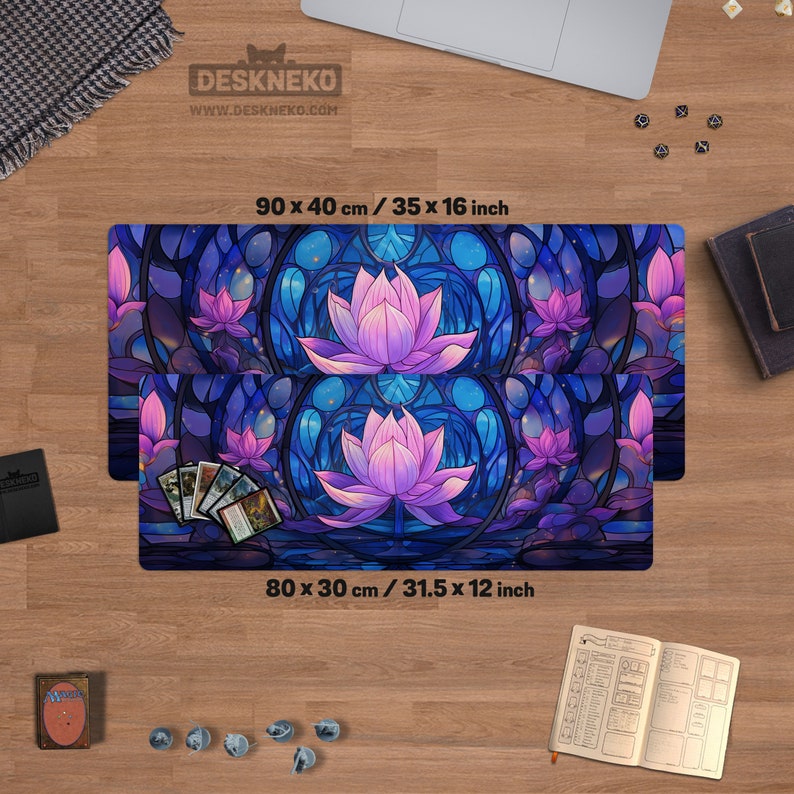 May include: Two rectangular desk mats with a stained-glass lotus flower design. The mats are 35 x 16 inches and 31.5 x 12 inches. The design features a purple lotus flower with blue and purple accents. The mats have the text "DESKNEKO" and "WWW.DESKNEKO.COM".
