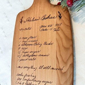 Small cherry cutting board with handwritten recipe engraved on it. Family recipe engraved on cutting board.