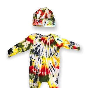 May include: A tie-dye baby onesie and matching hat in yellow, red, green, and black.