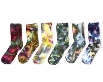 May include: Six crew-length socks arranged in a row, each featuring a unique tie-dye pattern. The colors include deep burgundy, earthy mustard and brown, bright yellow, dark forest green, muted grey and blue, and a mix of navy and white.