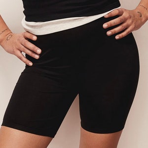 May include: Black biker shorts made of a stretchy fabric.