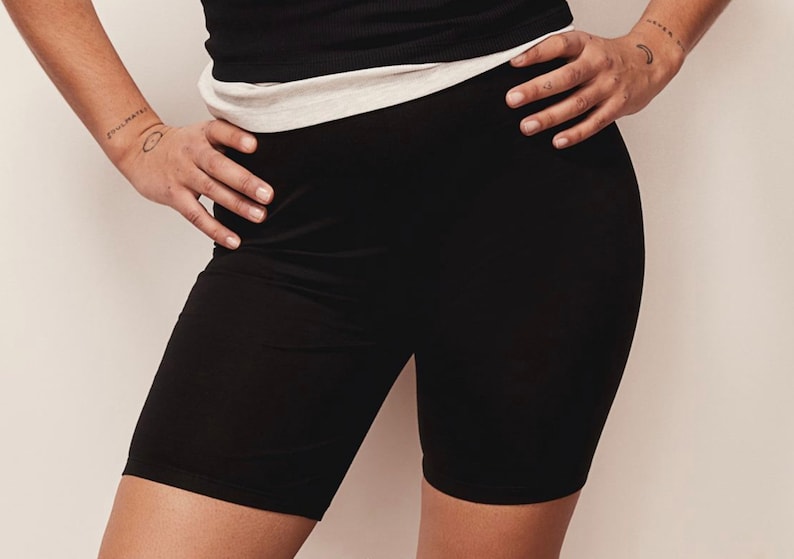 May include: Black biker shorts made of a stretchy fabric.