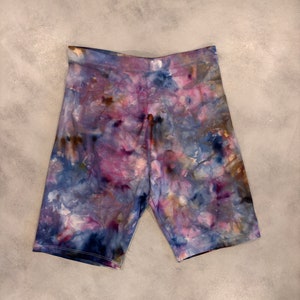 May include: Purple, blue, and brown tie-dye biker shorts.