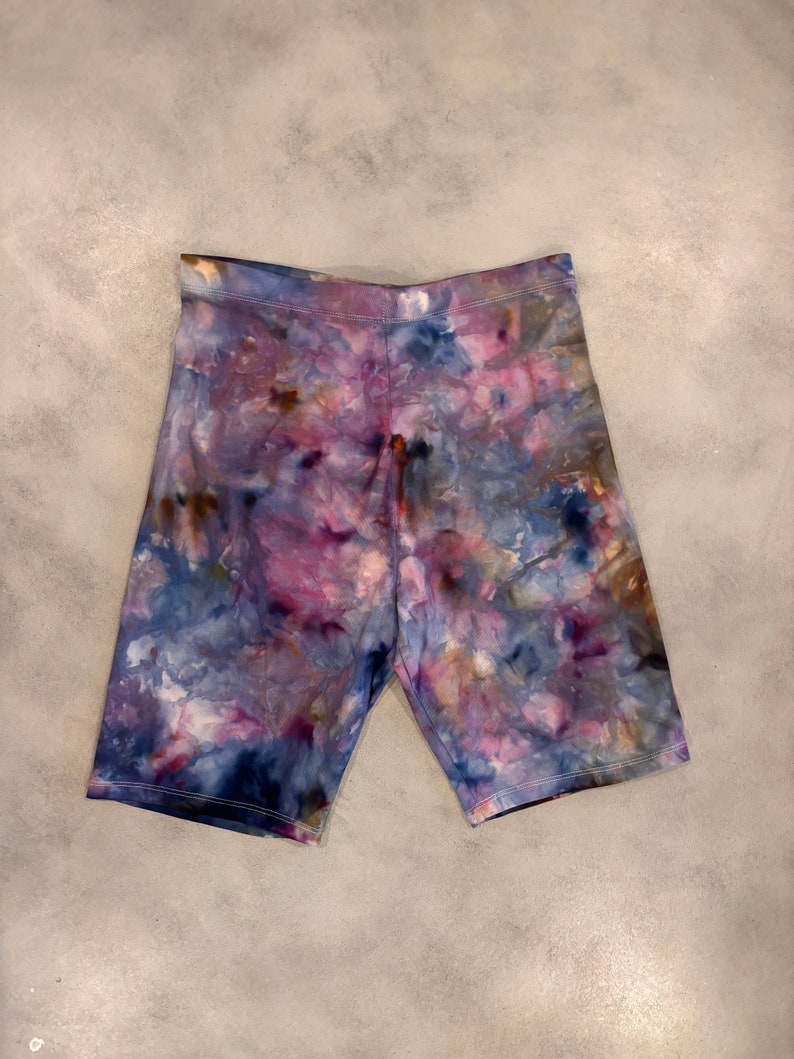 May include: Purple, blue, and brown tie-dye biker shorts.