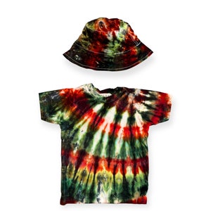 May include: A tie-dye t-shirt with a red, green, and black swirl pattern. The shirt has short sleeves and a round neckline. A matching red, green, and black bucket hat is also included.