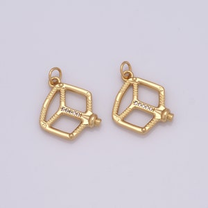 May include: Two gold-tone metal bike pedal charms with clear crystal accents.