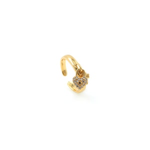 May include: Gold adjustable ring with a small heart-shaped charm that has a keyhole and is covered in clear rhinestones.