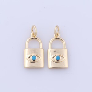 May include: Two gold lock charms with a blue evil eye design. The charms are perfect for adding a touch of style to necklaces, bracelets, or keychains.