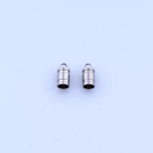 May include: Two small, cylindrical metal components with a loop at the top and an open bottom. The components are silver in color and appear to be made of stainless steel. They are likely used in jewelry making or crafting.