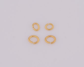 May include: Four gold-colored jump rings, two larger and two smaller, on a white background.