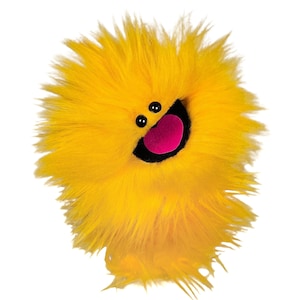 May include: A bright yellow plush puppet covered in long, shaggy faux fur. It features two small, round black eyes positioned above a wide, open mouth with a black interior and a prominent, rounded pink tongue centered inside the mouth.